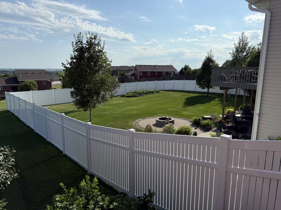 White vinyl privacy fence backyard